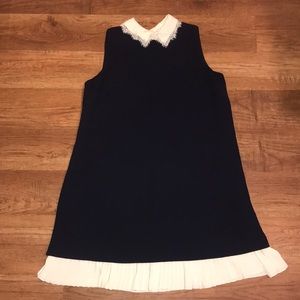 Sleeveless dress with lace collar & pleated skirt